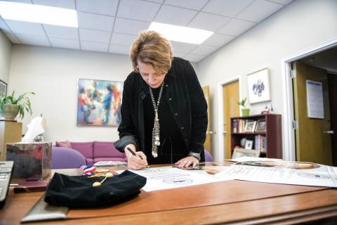 Employee Writing on a Desk